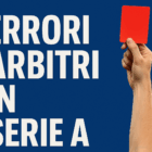 Arbitro di calcio mostra un cartellino rosso durante una partita di Serie A con la scritta “Errori Arbitri in Serie A” su sfondo blu.