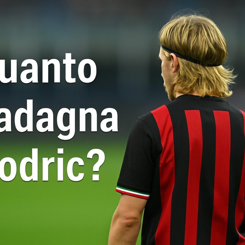 Giocatore biondo di spalle con fascetta e maglia rossonera in un campo da calcio, con la scritta Quanto guadagna Modric? in sovrimpressione