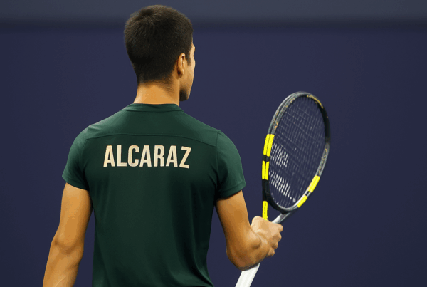Carlos Alcaraz di spalle sul campo da tennis, immagine 16:9 collegata all’articolo su Quanto guadagna Alcaraz.