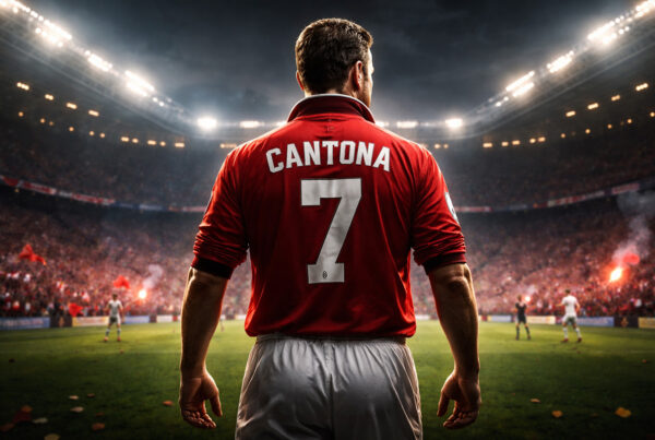 Eric Cantona di spalle con maglia numero 7 del Manchester United in uno stadio illuminato durante una partita serale