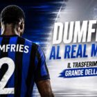 Grafica sportiva dedicata alla keyword “Dumfries al Real Madrid” con il calciatore olandese ripreso esclusivamente di spalle in una maglia dai colori nerazzurri. Sullo sfondo uno stadio illuminato è diviso tra tonalità blu e bianco-argento che richiamano rispettivamente Inter e Real Madrid senza utilizzare loghi ufficiali. In evidenza il titolo “DUMFRIES AL REAL MADRID?” e il sottotitolo “IL TRASFERIMENTO PIÙ GRANDE DELLA STORIA?”, elementi che richiamano le ultime indiscrezioni di mercato sul futuro dell'esterno olandese.
