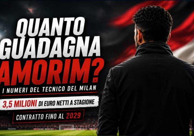 Quanto guadagna Amorim: grafica editoriale con il tecnico del Milan visto di spalle in uno stadio illuminato, bandiera astratta sfocata nei colori rosso, nero e bianco sullo sfondo e titolo dedicato allo stipendio dell'allenatore.