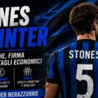 Stones all'Inter: immagine editoriale con il difensore di spalle davanti a uno stadio illuminato e una bandiera astratta nei colori nerazzurri, con il titolo dedicato alle visite mediche e alla firma.